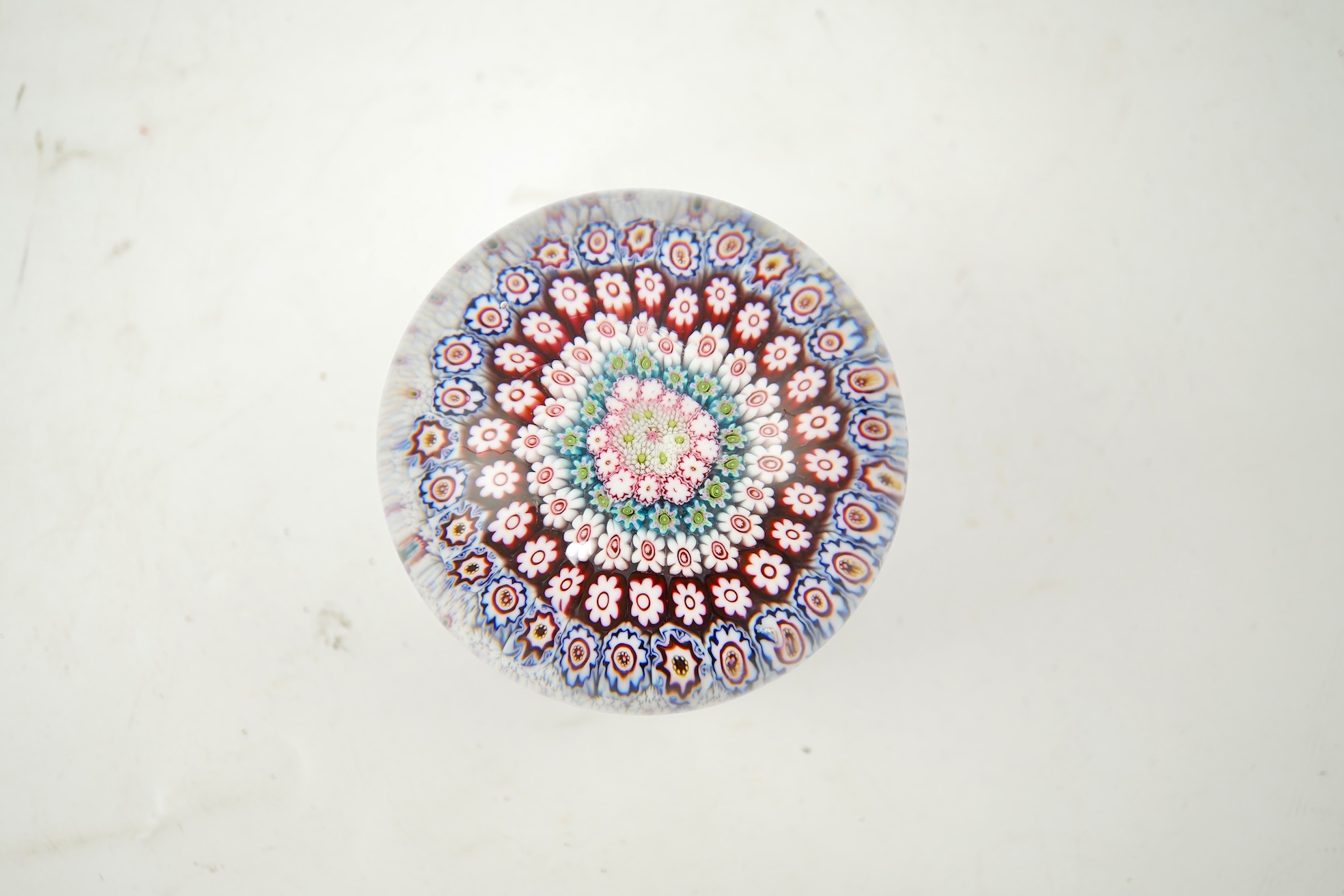 A Clichy piedouche concentric millefiori paperweight, mid 19th century
